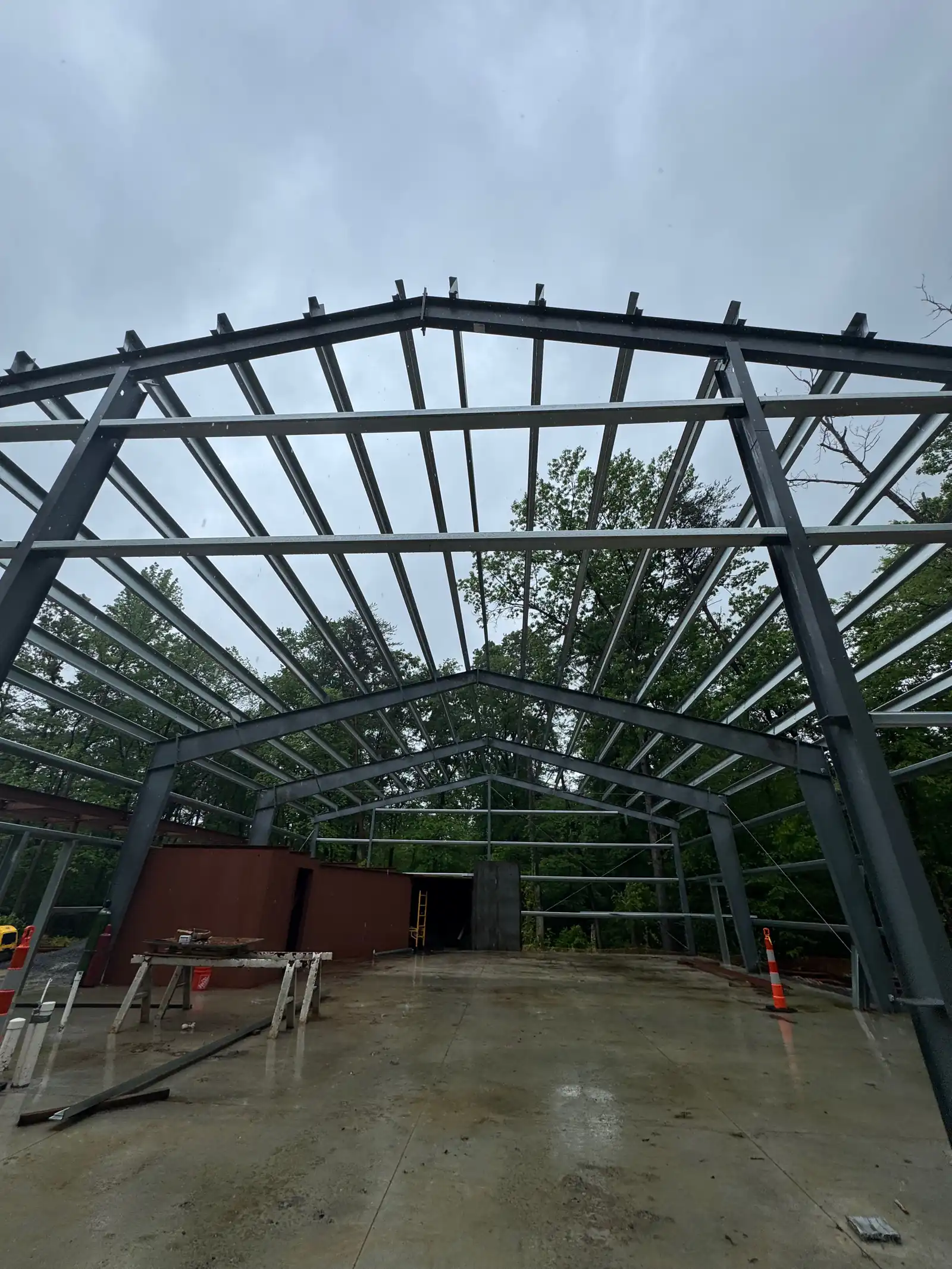 Clear-span steel rigid frame and roof purlins erected over a finished concrete slab